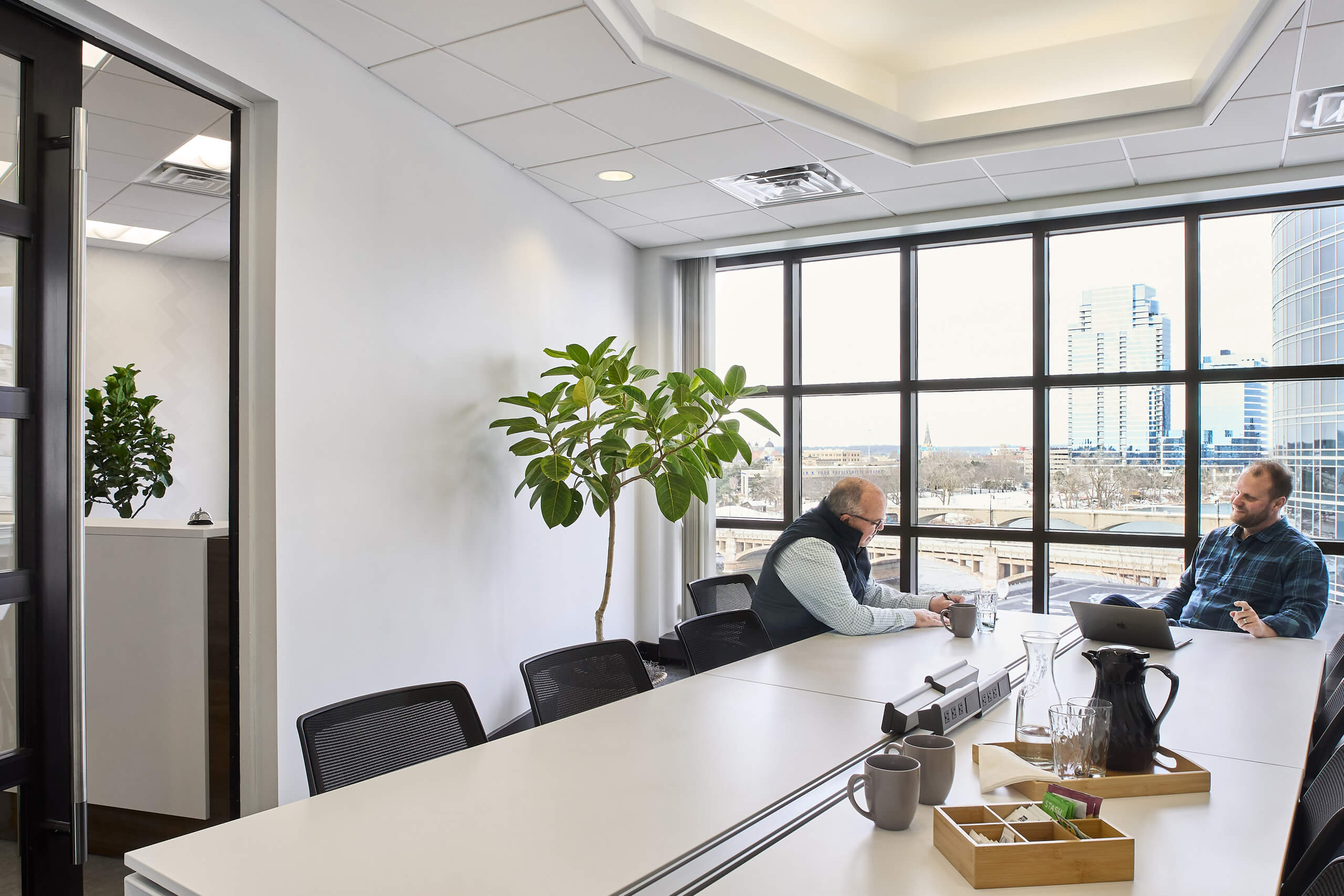 conference room with two men meeting at one end of the room