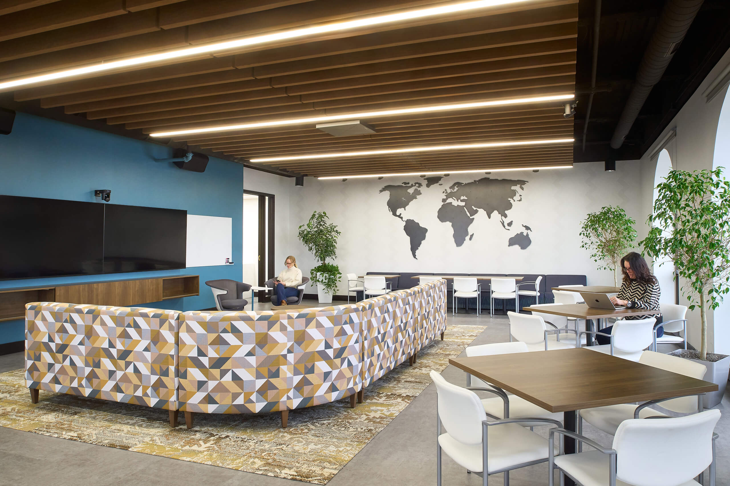 large multipurpose room with large metal world map on the wall