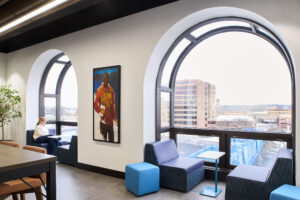 arched windows with cushioned seating within nooks that overlook the river and a blue bridge