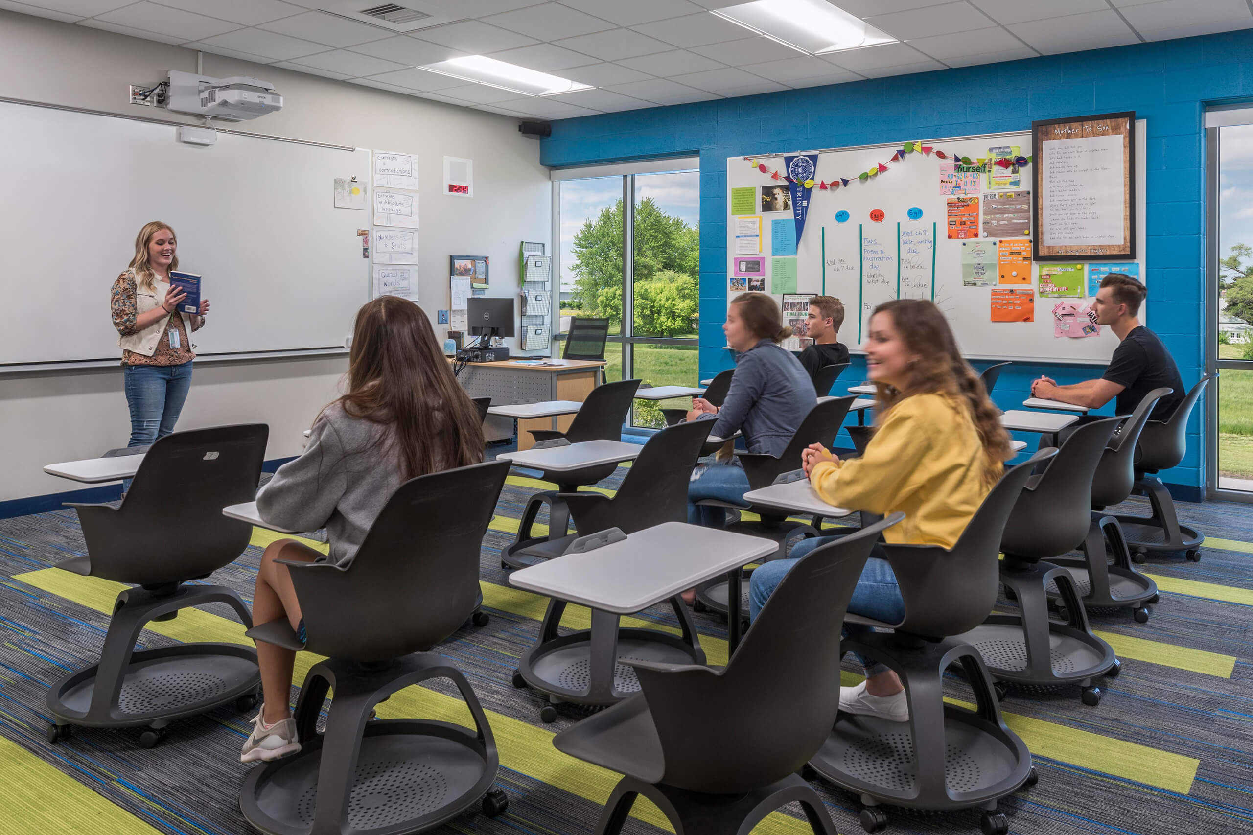students sitting in a classroom at movable desks