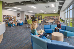 students utilizing soft seating in a library