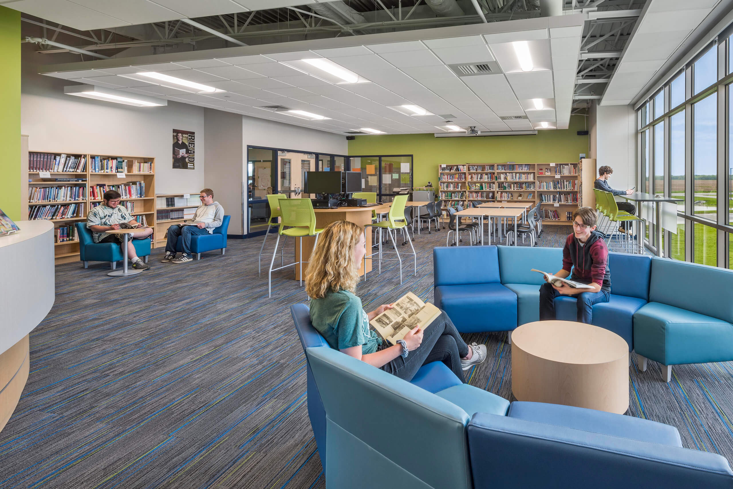 students utilizing soft seating in a library