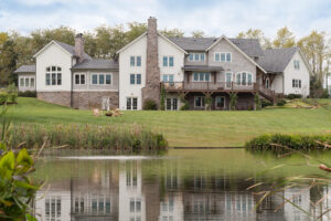exterior view of the back of a house from a view across the pond