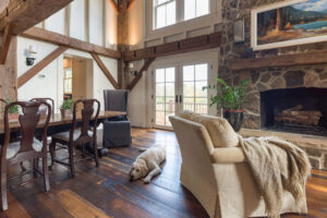 dining table adjacent to sitting area in front of stone fireplace